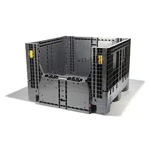 A large, black, heavy-duty plastic bulk container with drop-down doors, used for industrial parts storage.