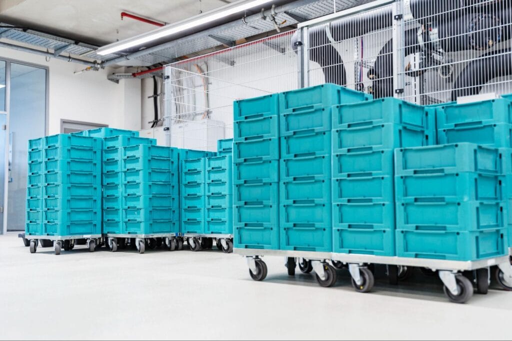 Modern facility featuring organized storage solutions with teal bins on wheels.