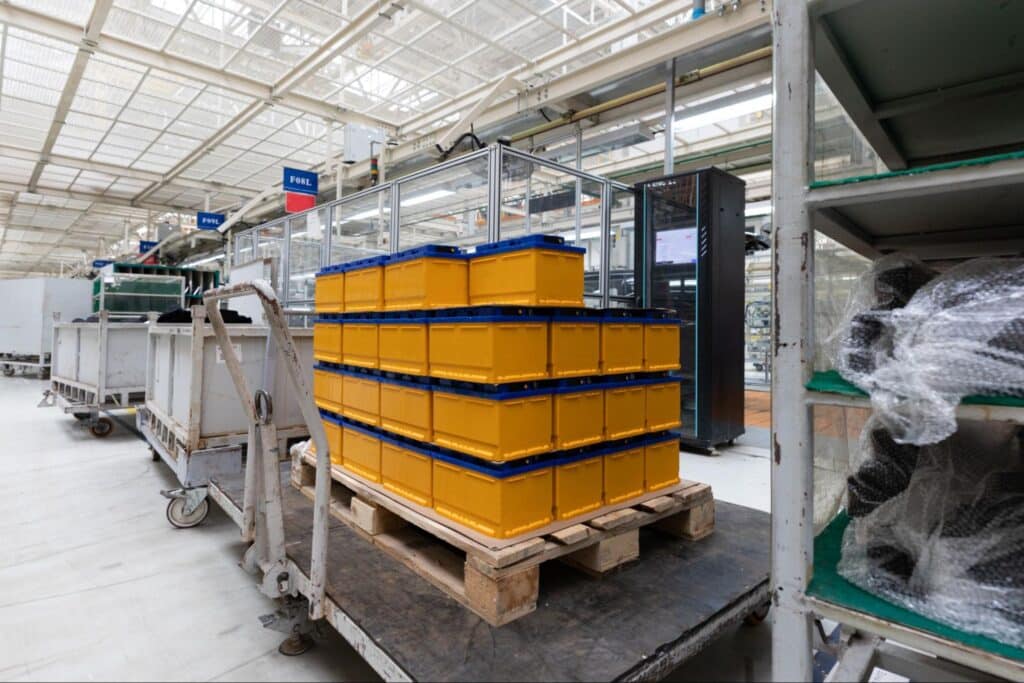 Yellow storage bins stacked for efficient organization in a modern warehouse.